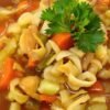 Bowl of vibrant cabbage soup with fresh vegetables.