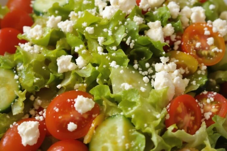 Vibrant salad with fresh greens, colorful vegetables, and a creamy dressing.