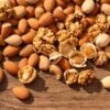 Assorted nuts on a wooden surface.