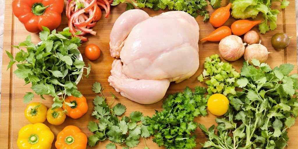 Colorful assortment of fresh ingredients on a wooden cutting board.