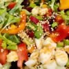 Colorful salad bowl with fresh vegetables and dressing.