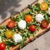Creative salad with rocket, tomatoes, and mozzarella.