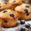 Healthy blueberry breakfast muffins on a wooden table.