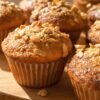 Golden brown All Bran Buds muffins on a wooden board.