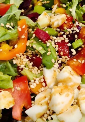 Colorful salad bowl with fresh vegetables and dressing.