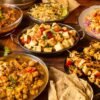 Assorted high-protein Indian dishes on a wooden table.