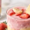 Costco strawberry banana smoothie with fresh fruit garnish.