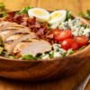 Colorful Cobb salad with chicken, bacon, eggs, and avocado