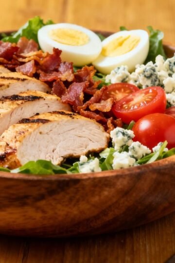 Colorful Cobb salad with chicken, bacon, eggs, and avocado