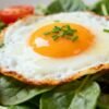 Healthy breakfast eggs with spinach and tomatoes.