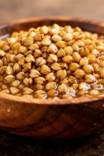 Soaked buckwheat groats in a wooden bowl.
