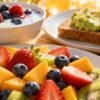 Healthy low-calorie breakfast items with fresh fruits and yogurt.