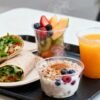 Healthy fast food breakfast tray with fruits and wraps