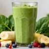 Healthy green smoothie with banana and berries.