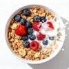 Bowl of heart-healthy cereal with berries and milk.