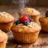 Healthy breakfast muffins with berries on a wooden surface.