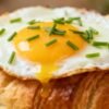 Egg and croissant breakfast combination.