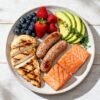 Healthy breakfast meats with fruits and avocado.