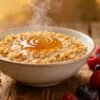 Bowl of buckwheat porridge with berries and honey.
