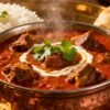 Mutton curry with rice and naan bread.