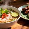 Authentic Laotian breakfast dishes: noodle soup, sticky rice, grilled meat.