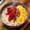 Bowl of healthy oatmeal with fresh fruit and nuts.
