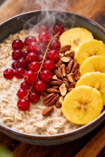 Bowl of healthy oatmeal with fresh fruit and nuts.