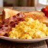 Delicious breakfast spread with eggs, bacon, and toast.