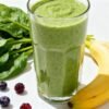 Healthy green smoothie with fresh fruits and spinach.