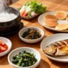 Traditional Korean breakfast spread with rice, kimchi, and side dishes.