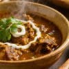 Delicious mutton curry with fresh cilantro garnish.