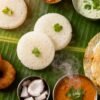 South Indian breakfast spread with idlis, dosas, and chutney.