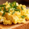 Scrambled eggs on toast with chives.