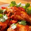 Spicy Indian chicken dish with cilantro garnish.