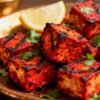 Grilled paneer tandoori with char marks and cilantro garnish.