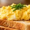 Scrambled egg on toast with chives.