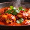 Spicy Indian chicken dish with cilantro and chili flakes.