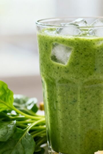 Healthy green breakfast smoothie with banana and spinach.