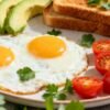 Delicious breakfast eggs with colorful sides and toast.