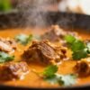 Tender Crock Pot lamb curry with cilantro garnish.