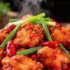 Authentic Chinese Chilli Chicken dish with garnishes.