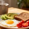 Healthy egg breakfast with toast, avocado, tomatoes, coffee