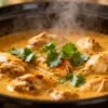 Slow cooker chicken curry in a bowl with cilantro.