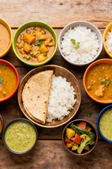 South Indian meal prep bowls with colorful curries and rice.