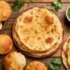 Assortment of Indian flatbreads like roti, puri, and paratha.