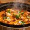 Slow cooker Indian curry chicken with cilantro garnish.