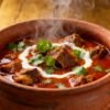 Authentic Indian mutton curry in a clay pot.