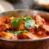 Authentic Indian chicken curry with spices and cilantro.