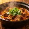 Slow cooker lamb curry with cilantro garnish.