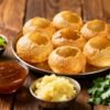 Crispy pani puris with bowls of flavored water.